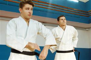Black belt men in karate class